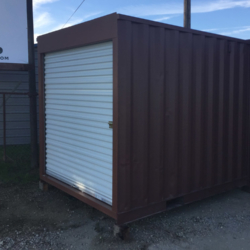 Shipping container with roll up door