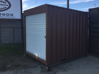Shipping container with roll up door