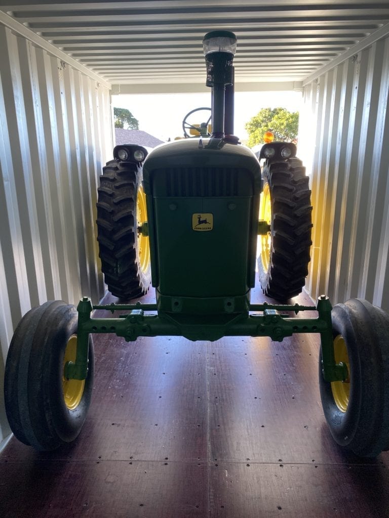 Tractor in shipping container storage